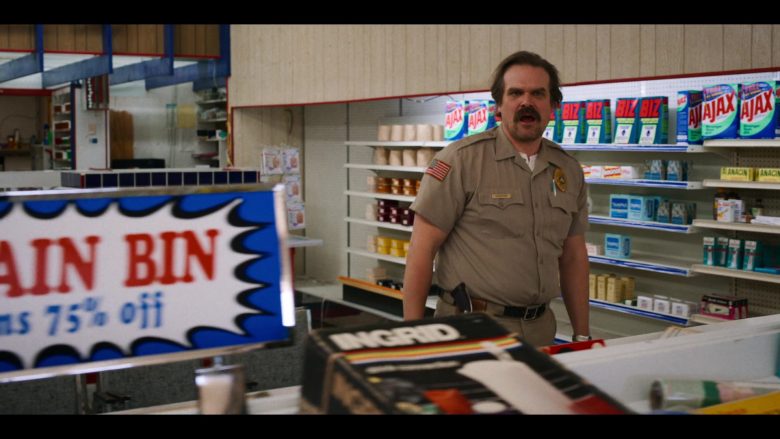 David Harbour standing in front of a store