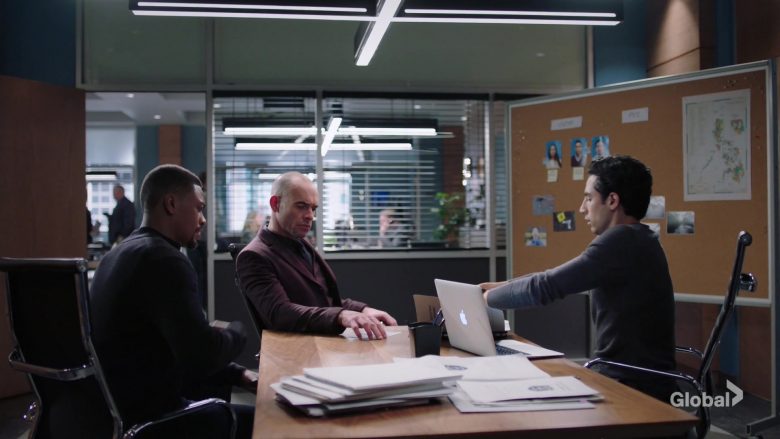 Paul Blackthorne et al. sitting at a table in front of a computer