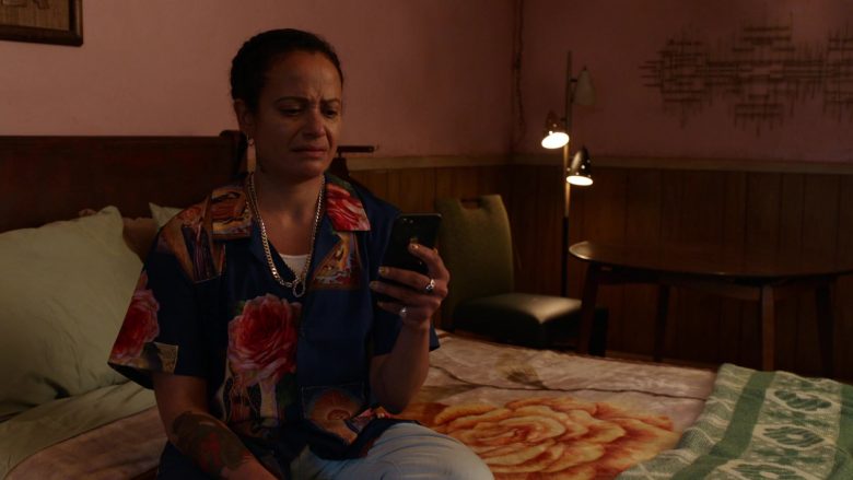 Judy Reyes sitting on a bed