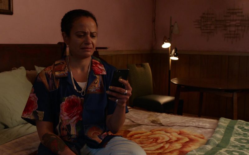 Judy Reyes sitting on a bed