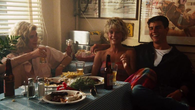 Tom Cruise et al. sitting at a table with food