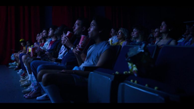 A group of people sitting in a dark room