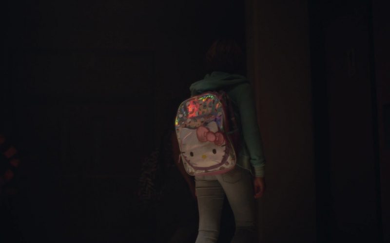 A girl standing in a dark room