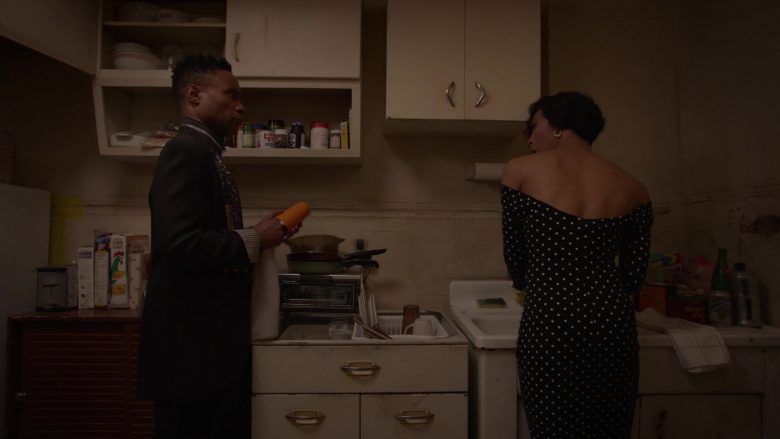 A man and a woman standing in a kitchen