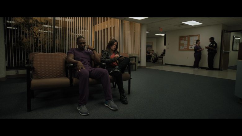 A man and a woman sitting on a bench in a room