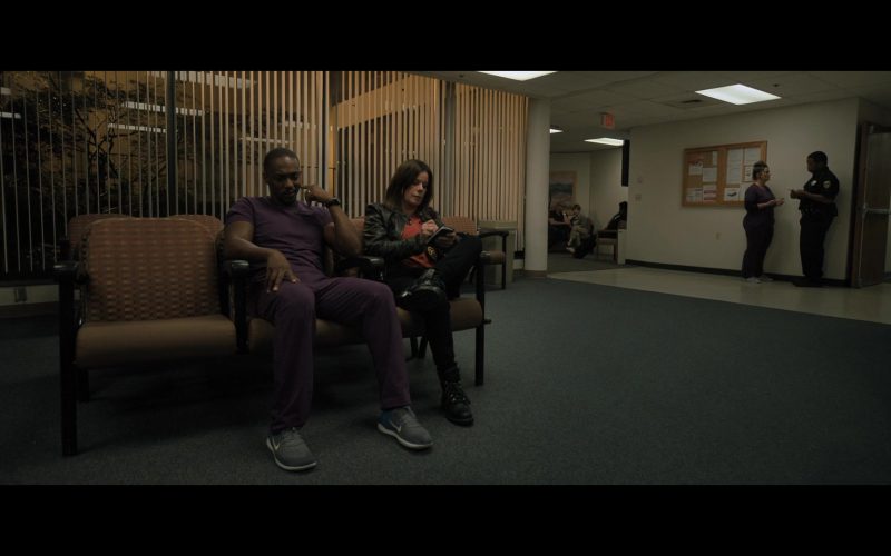 A man and a woman sitting on a bench in a room
