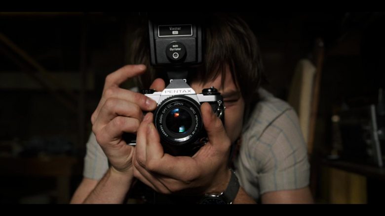 A man holding a camera in front of a mirror posing for the camera