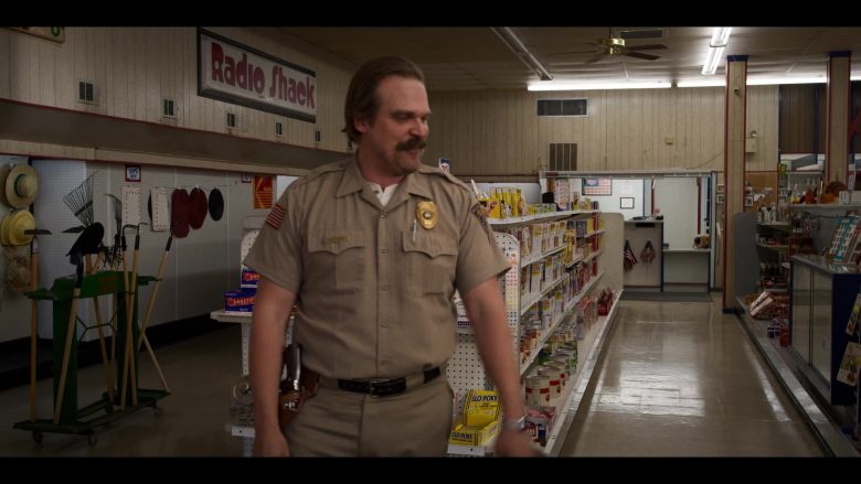 David Harbour standing in a store