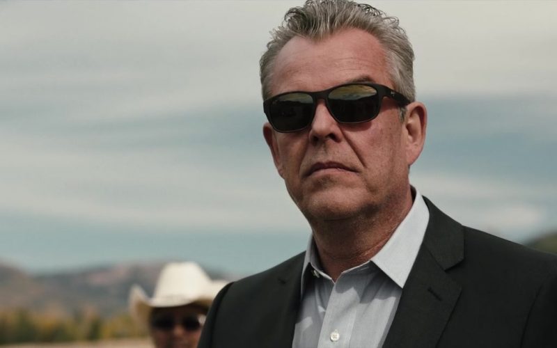 Danny Huston wearing a suit and sunglasses posing for the camera