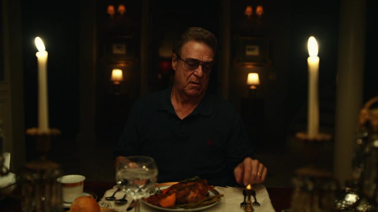John Goodman sitting at a table with wine glasses
