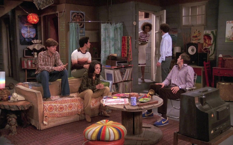 Ashton Kutcher as Michael Kelso Wears Nike Sneakers, Brown Velvet Trousers and Striped Shirt Outfit in That '70s Show