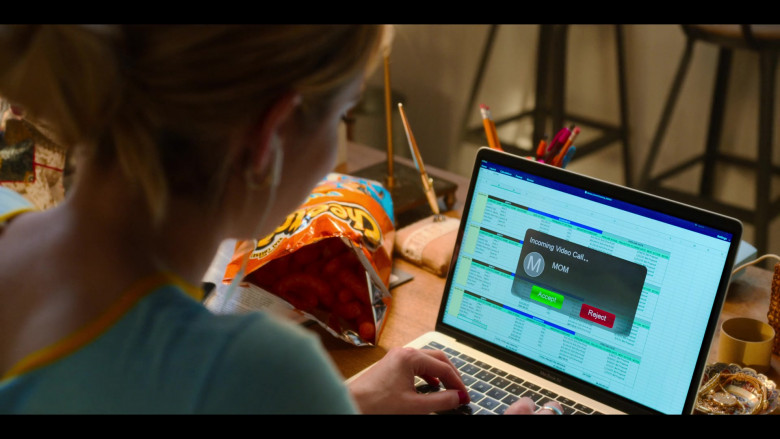 Apple MacBook Air Laptop and Cheetos Snack of Emma Roberts as Sloane in Holidate Movie (2)