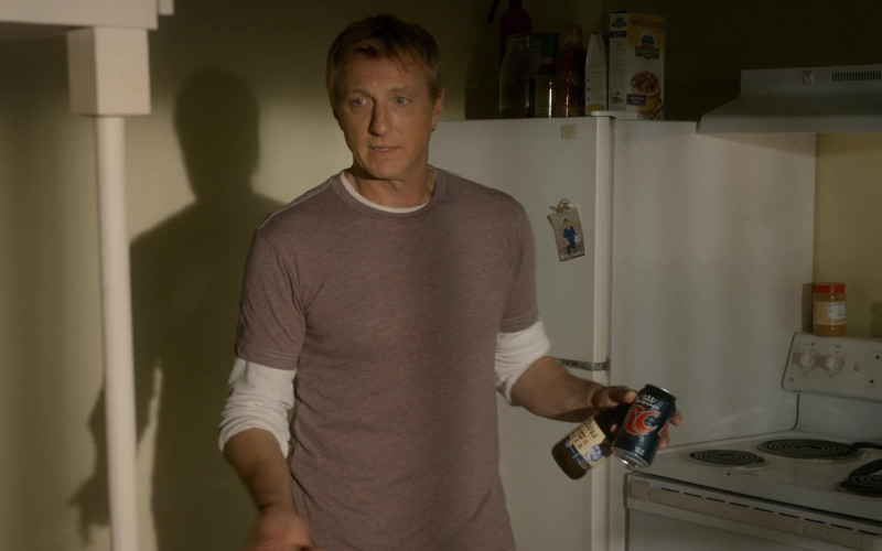 RC Cola and Coors Banquet Beer Cans Held by William Zabka as Johnny Lawrence in Cobra Kai S03E06
