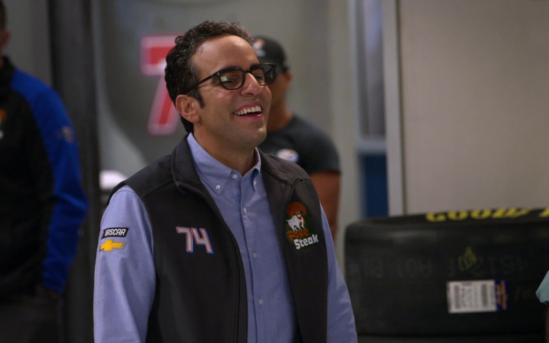 Chevrolet Patch on the Blue Shirt of Dan Ahdoot as Amir in The Crew S01E08
