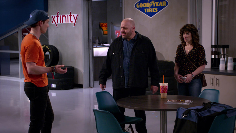 Xfinity and Goodyear Tires Signs and Dunkin' Coffee Drink in The Crew S01E01