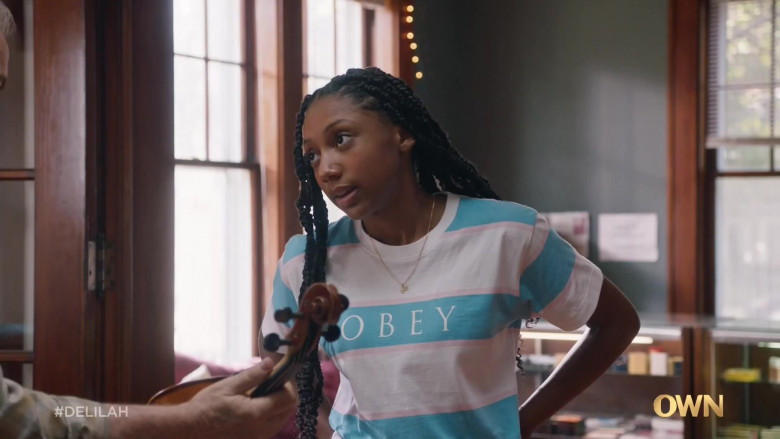 Obey Women's T-Shirt of Kelly Jacobs as Maia in Delilah S01E01 Everything to Everybody (2021)