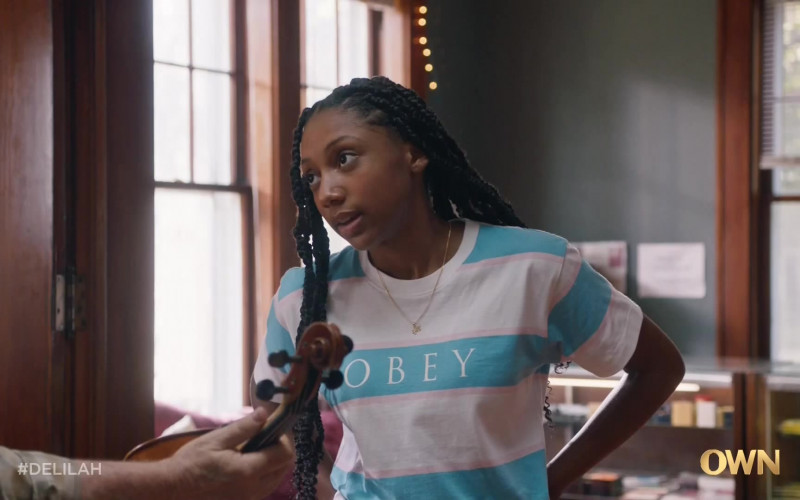 Obey Women’s T-Shirt of Kelly Jacobs as Maia in Delilah S01E01 Everything to Everybody (2021)