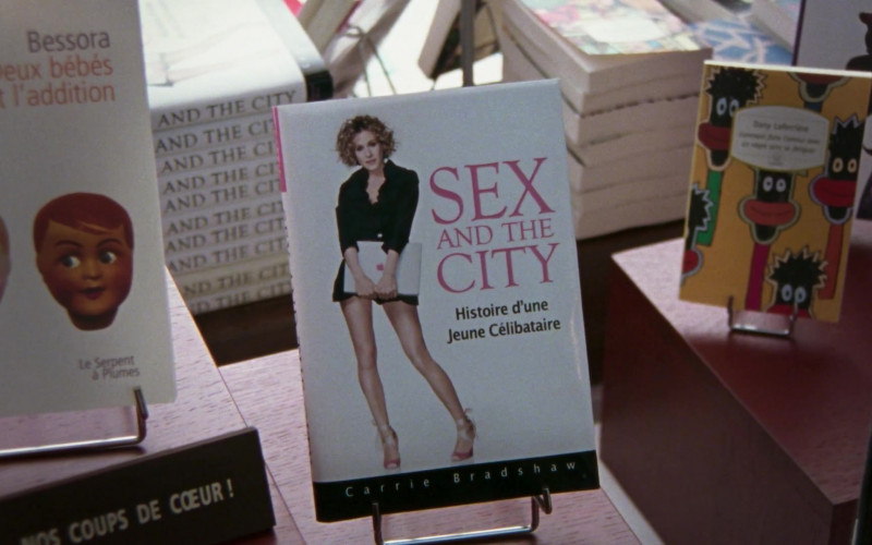 Apple Laptop (on the cover of the book) Held by Sarah Jessica Parker as Carrie Bradshaw in Sex and the City S06E20 An American Girl In Paris (Part Deux) (1)