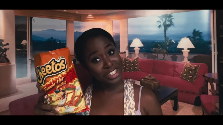 CHEETOS Crunchy FLAMIN’ HOT Cheese Flavored Snacks Held by Kirby Howell-Baptiste as JoJo Johnson in Queenpins Movie (1)