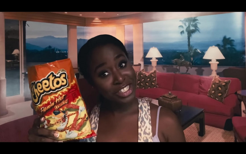 CHEETOS Crunchy FLAMIN' HOT Cheese Flavored Snacks Held by Kirby Howell-Baptiste as JoJo Johnson in Queenpins Movie (1)