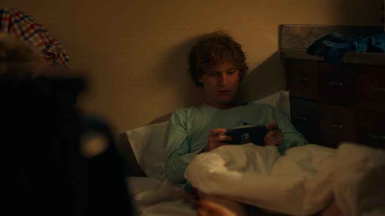 Nintendo Switch Video Game Console of Fred Hechinger as Quinn Mossbacher in The White Lotus E01 Arrivals (2021)