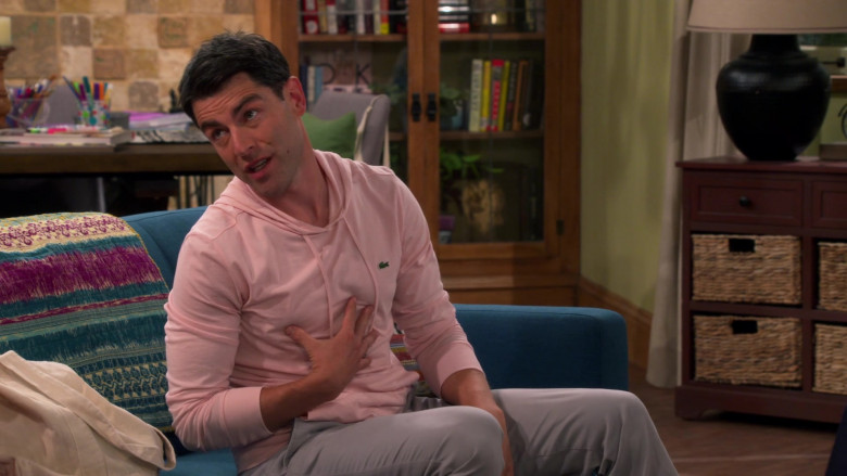 Lacoste Pink Hoodie of Max Greenfield as Dave Johnson in The Neighborhood S04E01 Welcome to the Family (2021)