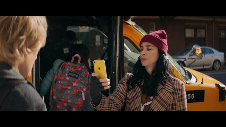 JanSport Floral Print Backpack and Apple iPhone Smartphone in Marry Me (2022)