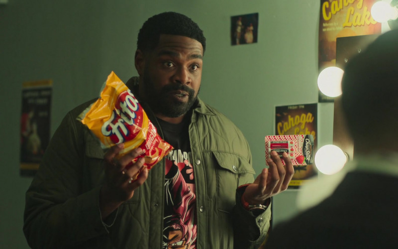 Fritos Original Corn Chips and ChapStick Lip Balms Held by Ron Funches as Howard in Loot S01E09 Cahoga Lake (2022)