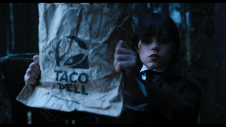 Taco Bell Fast Food Restaurant Paper Bag Held by Jenna Ortega as Wednesday Addams in Wednesday S01E03 Friend or Woe (2022)