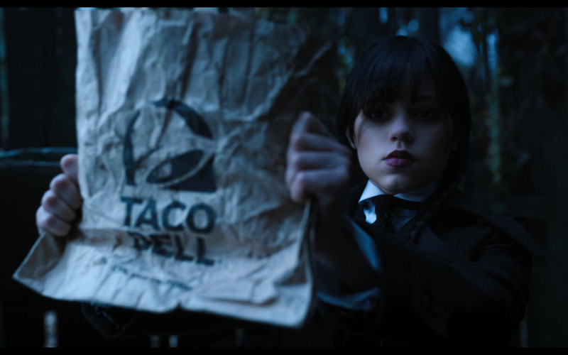Taco Bell Fast Food Restaurant Paper Bag Held by Jenna Ortega as Wednesday Addams in Wednesday S01E03 Friend or Woe (2022)