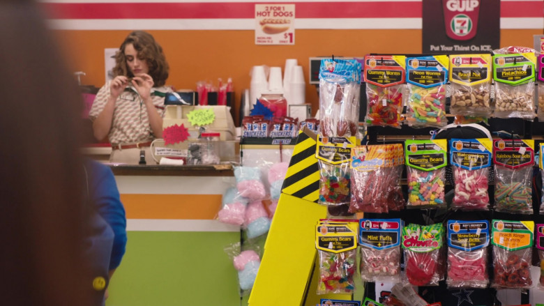 King Henry's Candies, Snickers Chocolate Bars, 7-Eleven Big Gulp Drink Sign in Young Rock S03E07 World Pacific Wrestling (2023)