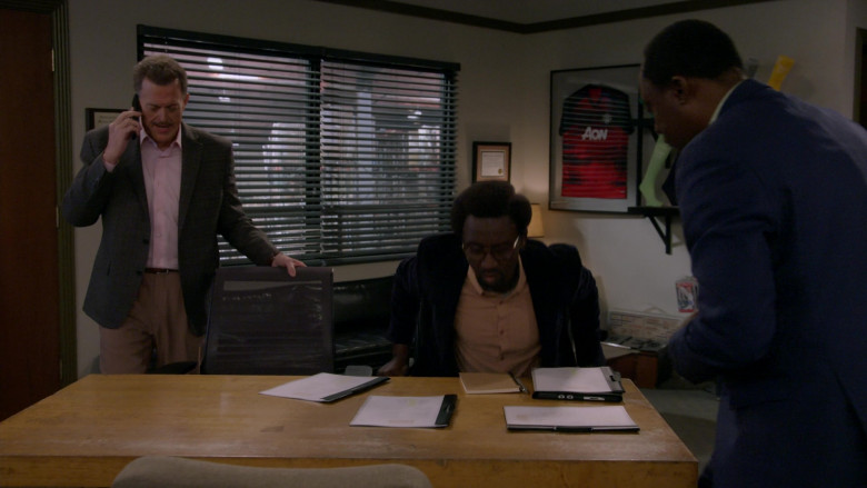 Aon Insurance Company T-Shirt in Bob Hearts Abishola S04E16 Mmm, Fresh Baked Sock! (2023)