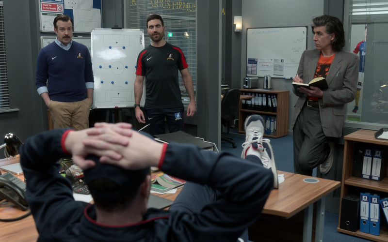 New Balance Sneakers of Brendan Hunt as Coach Beard and Nike Tops Worn by Jason Sudeikis & Brett Goldstein in Ted Lasso S03E03 4-5-1 (2023)