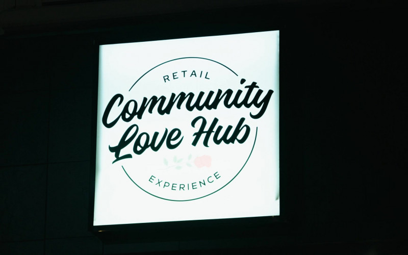 Community Love Hub Store in Hush S02E06 "Son of a Gun" (2024)